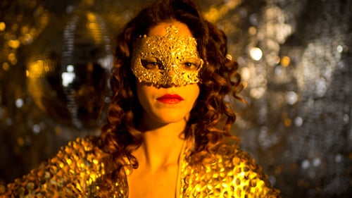 Woman Dances in Gold Jacket and Mask