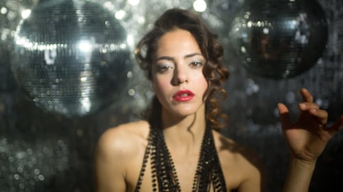 Glamorous Woman Dancing in Disco Setting