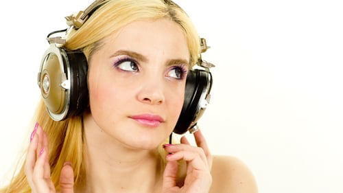 Woman Listens to Music with Vintage Headphones