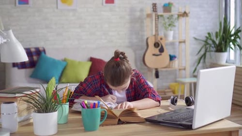 Girl Doing Schoolwork at Home at Desk