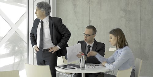 Collaborative Team Analyzing Documents in Bright Modern Workplace