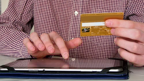 Person Shopping Online with Credit Card and Tablet