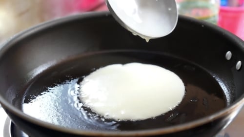 Pancake Batter Cooking in a Frying Pan