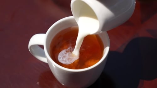 Pouring Milk into Mug of Tea and Stirring