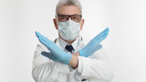 Doctor in Surgical Mask Showing Stop Gesture