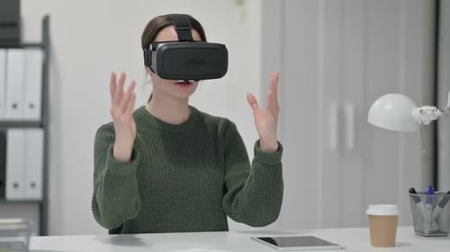 Woman Using Virtual Reality Headset at Desk