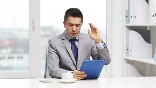 Man Uses Tablet in Bright Modern Office