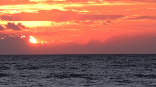 Golden Sunrise Over Still Ocean Waters