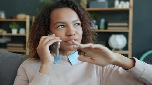 Young Woman Chatting on Smartphone Indoors