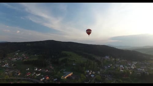 Balloon Flies Above a Small Town Closer To the Woods