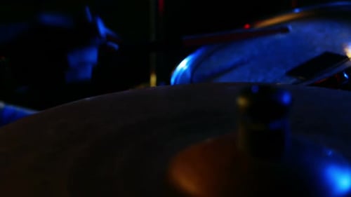Drummer Plays Cymbal Under Blue and Red Lights