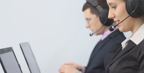 Two Call Center Operators Working in Office