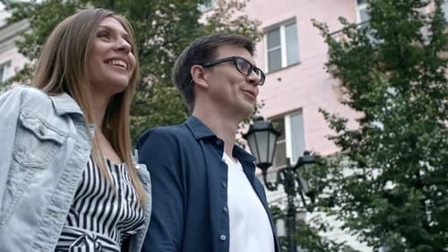 Joyous Couple Chatting and Smiling during Walk