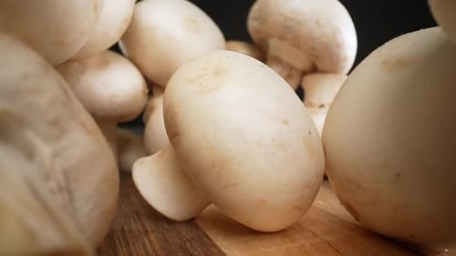 Fresh White Mushrooms on a Cutting Board