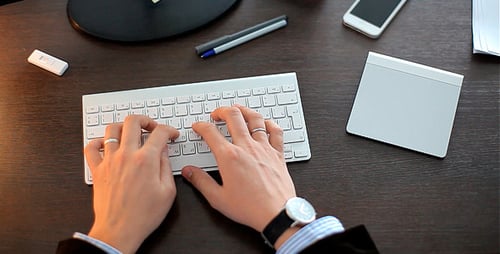 Businessman Working and Typing on a Keyboard
