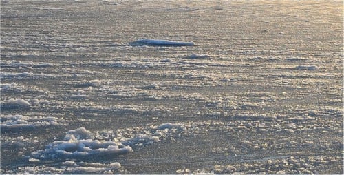 Frozen Landscape with Ice and Snow at Sunrise