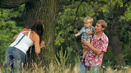 Family Fun Outdoors Playing near a Tree