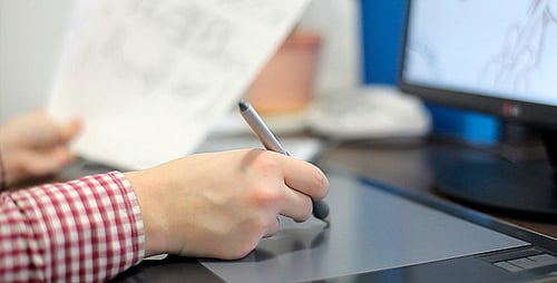 Artist Using Graphic Tablet for Digital Drawing