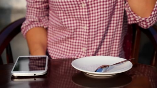 Woman Using Mobile Phone and Drinking Coffee