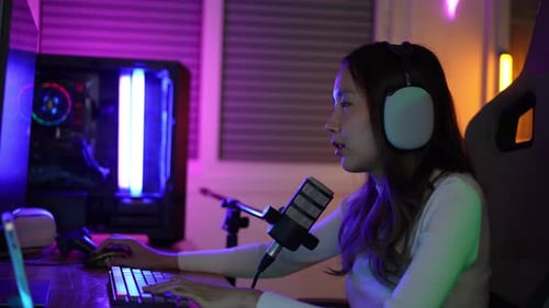 Woman Playing Video Game in Neon Lit Room