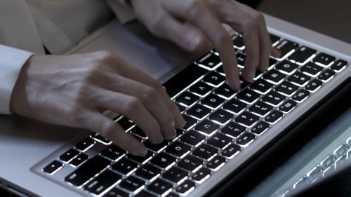 Businesswoman Typing On Laptop