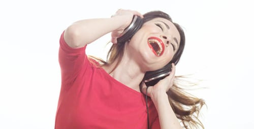 Excited Woman Listening to Music on Headphones