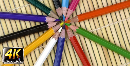 Colorful Pencils Arranged on Bamboo Mat