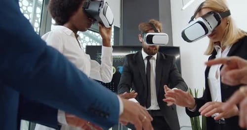 Business People Wearing VR Headsets in Modern Office