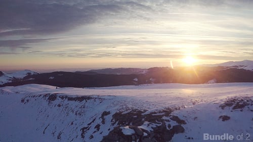 Aerial Shot of Snowy Mountains at Sunset