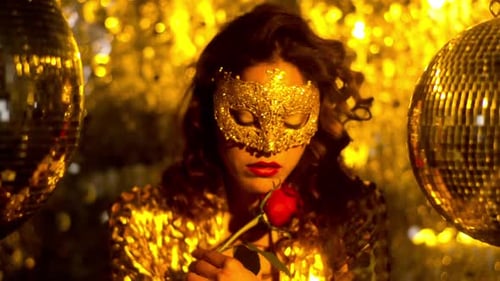 Glamorous Woman with Gold Mask Smelling Rose