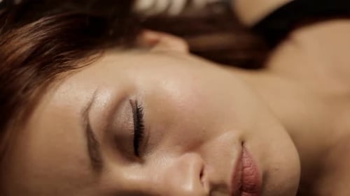 Young Woman Opens Eyes Slowly, Close Up