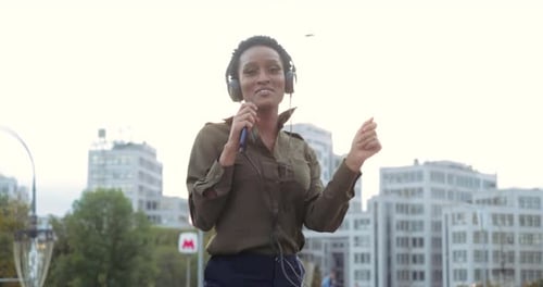Active Cheerful Young Girl Teenager Resting Walking in Street in Fresh Air Listening Music Online in
