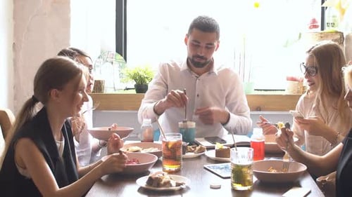 Colleagues Eating Lunch Together in a Cafe