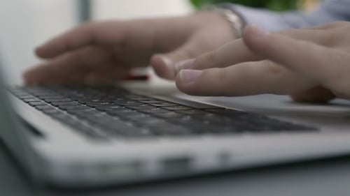Close Up of Hands Typing on Laptop Keyboard