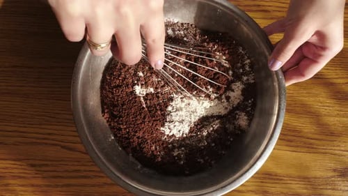 Whisking together cocoa powder and flour