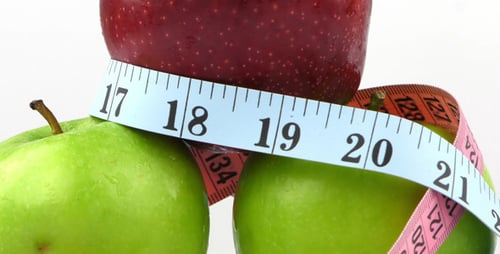 Apples Stacked With Measuring Tape