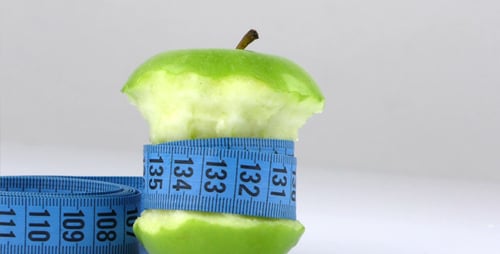 Eaten Green Apple Wrapped in Measuring Tape