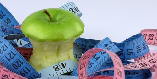 Apple Core Surrounded by Measuring Tapes