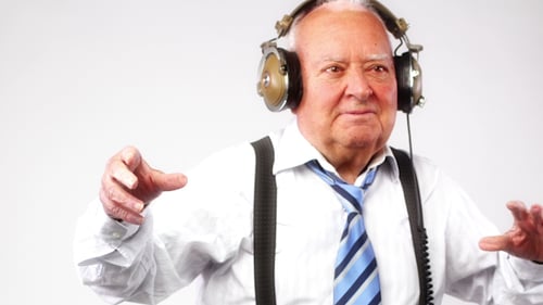 Enthusiastic Senior Adult Enjoying Music on Turntable