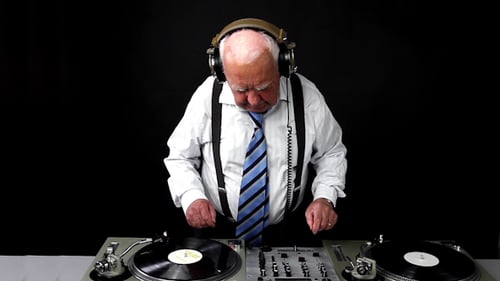 Senior Man Mixing Music on DJ Turntables
