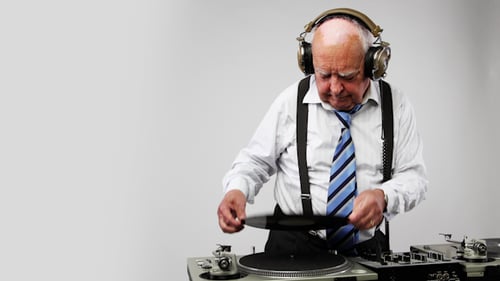 Senior Man Playing Vinyl Record on Turntable