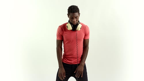 Man Dances with Headphones Against White Background