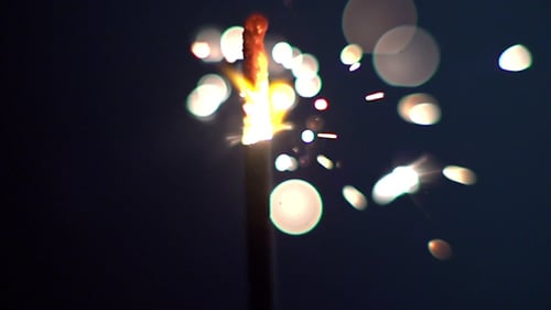 Burning Sparkler Emitting Bright Sparks in the Dark