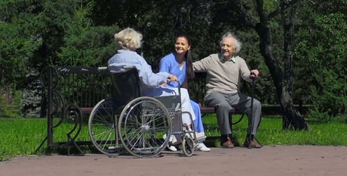 Elderly Couple Relaxing on Bench in the Park