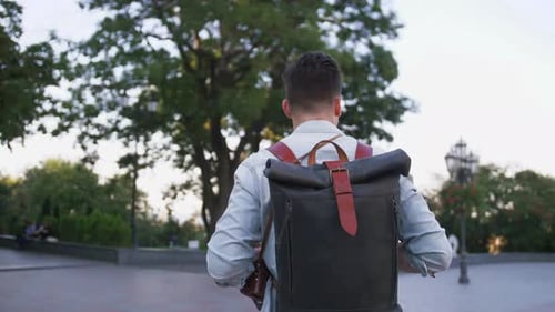 Attractive Young Handsome Man Tourist with Backpack Walking in City Center