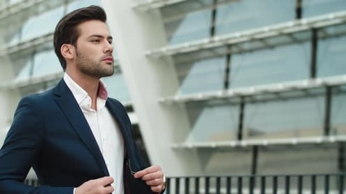 Portrait Businessman Walking Outdoors. Man Looking Away Outdoors at City