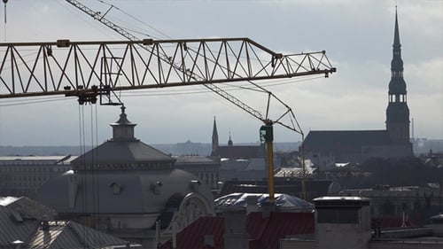 Crane Above City Buildings on an Overcast Day