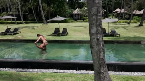 A Panning Shot of a Happy Couple Having Fun in a Swimming Pool