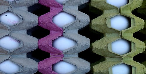 Eggs Nestled in Colorful Painted Cardboard Cartons