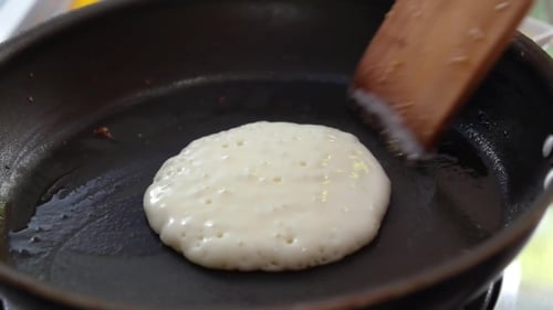 Close Up Of Making Homemade Pancakes On Frying Pan